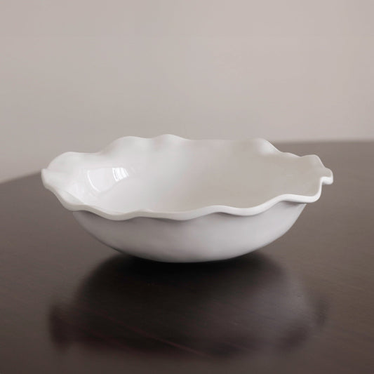 White serving bowl with a wavy, ruffled edge. Available in large and medium sizes.