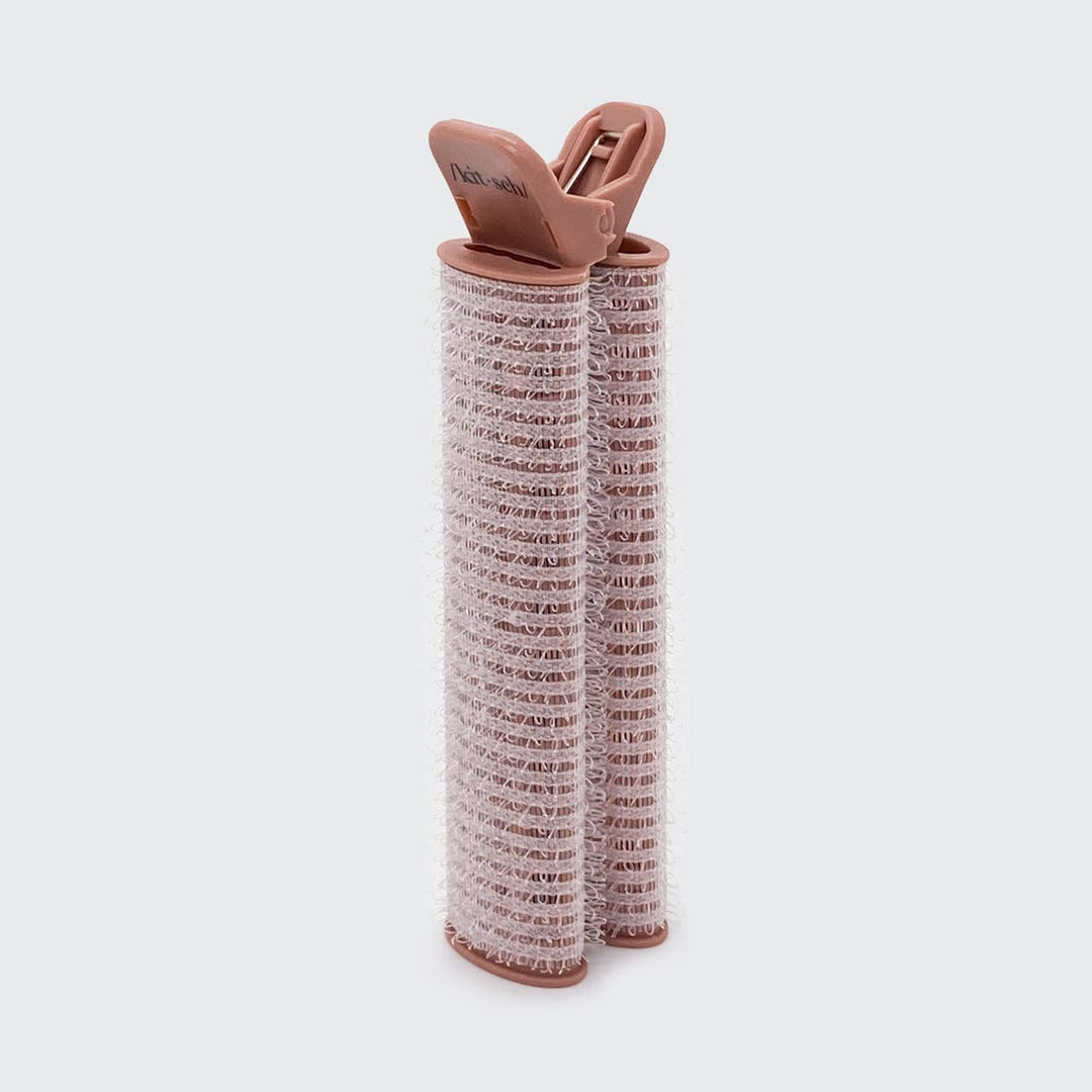 Two pink Volumizing Roller Clips with textured surfaces for curls and volume. Available in small and large sizes.