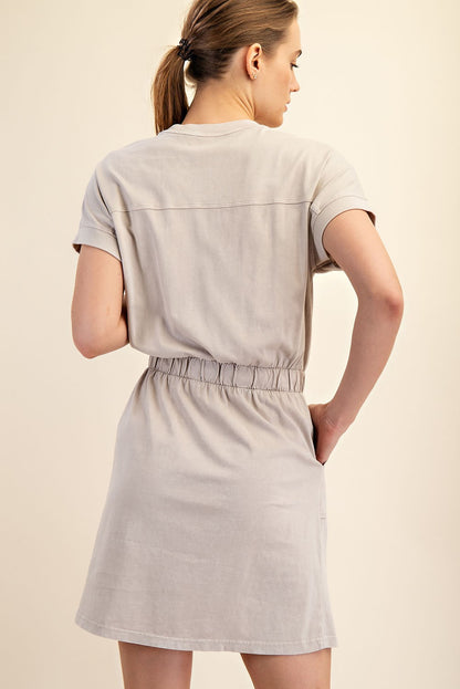 Mineral Washed Elastic Waist Cotton Dress in light beige. Features an elastic waistband, mini length, and turned-up sleeves. Sizes available: S, M, L.