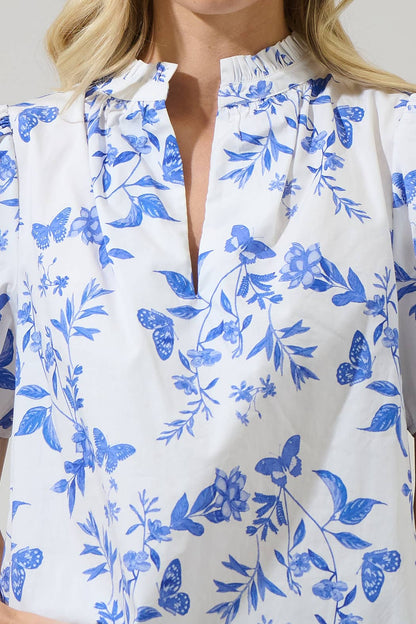 Leya Floral Inaya Split Neck Top: blue/white, butterfly/floral print, ruffled collar, split neck. Sizes XS-XL.