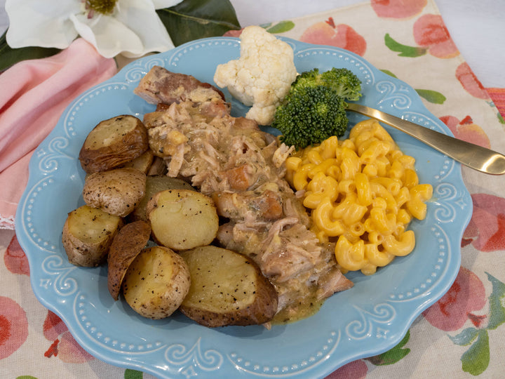 Country Ranch Porkchops in gravy on a blue plate. Sizes available: Small, Medium, Large.