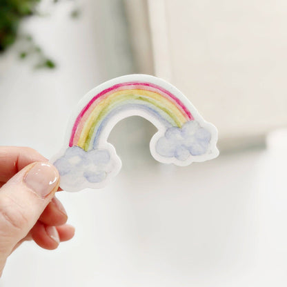 Small vinyl Rainbow sticker with pastel colors and fluffy clouds, inspired by Emily Lex. Available in multiple sizes.