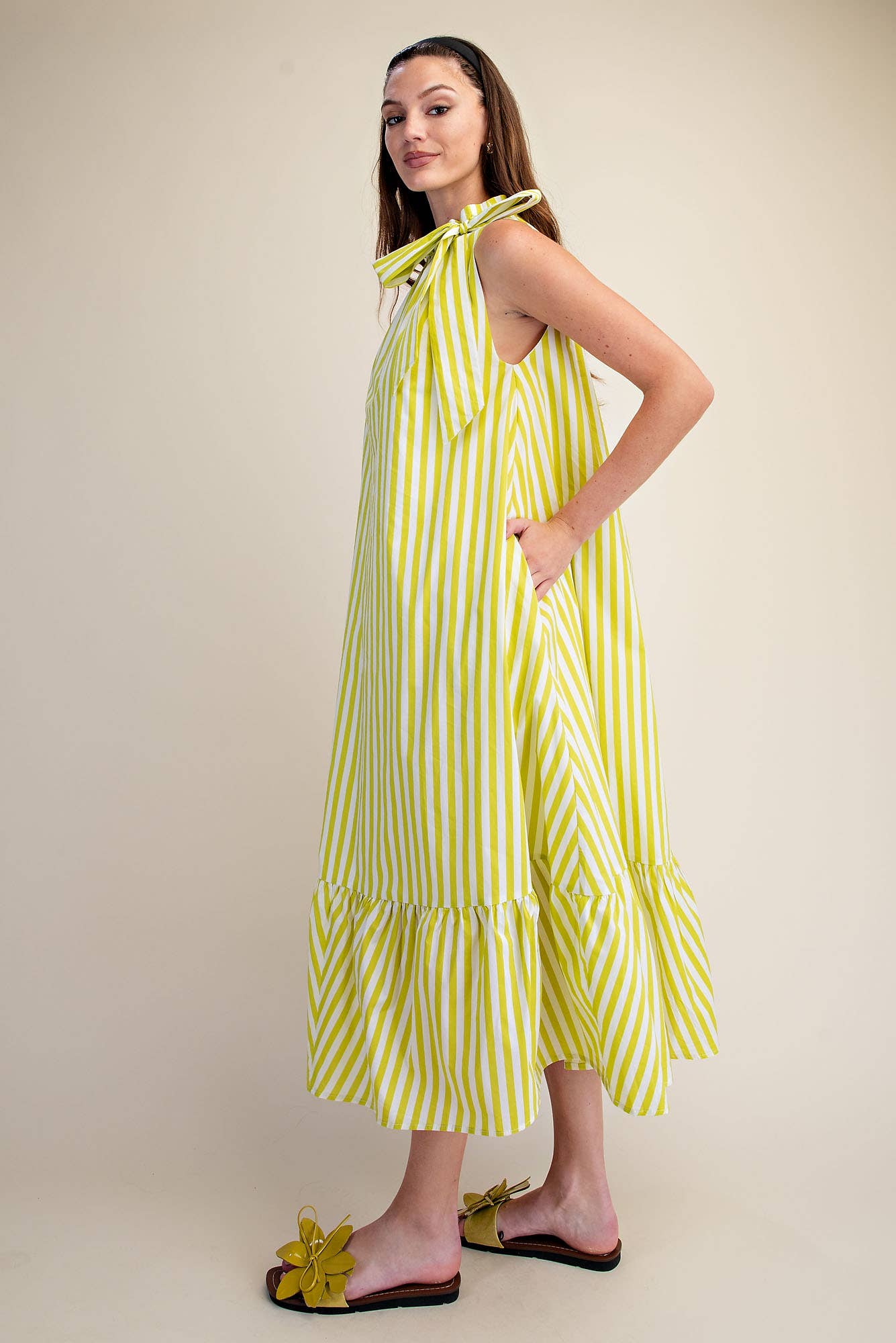 Navy stripe midi dress with sleeveless ruffle neck tie. Available in sizes XS-XL.