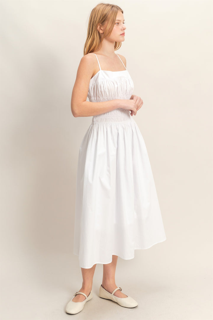 Smocked Strapped Midi Dress in white with thin straps and smocked bodice. Available in XS–XL.
