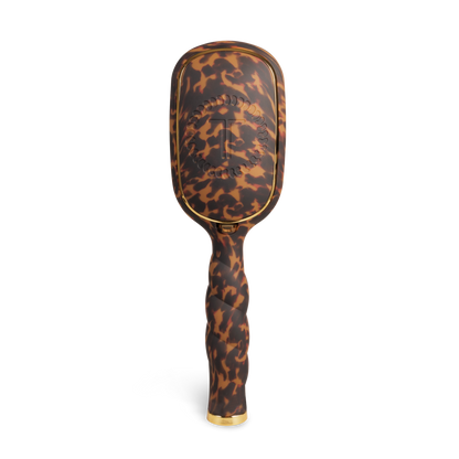 The Detangler Hair Brush for Thick Hair - Tortoise has a brown tortoiseshell pattern, gold accents, and a raised decorative back design; available in multiple sizes.
