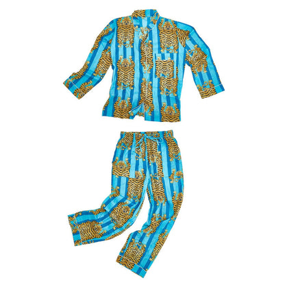 Eye of the Tiger Cotton Printed Pajamas: Vibrant blue and white stripes with yellow/orange tiger motifs, long-sleeved collared shirt with buttons and chest pocket, pants with elastic waistband. Available in sizes S, M, L, XL.