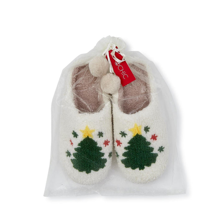 Cream plush slippers with green Christmas tree and yellow star pattern in a sheer drawstring bag.