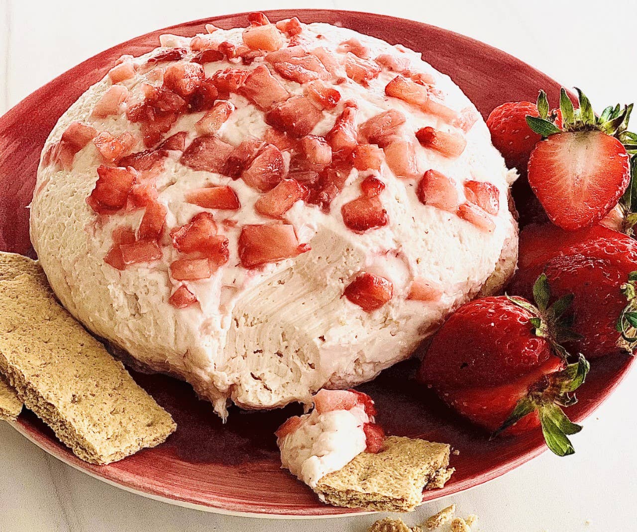 Strawberries N Cream Cheesecake Dip—creamy, all-natural dip with chopped strawberries topping. Available in 8oz or 16oz sizes.