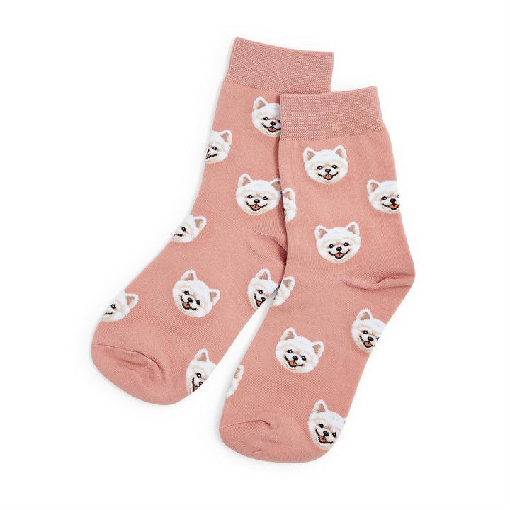 Pink cotton socks with a repeating white dog face pattern. Available sizes: S, M, L.