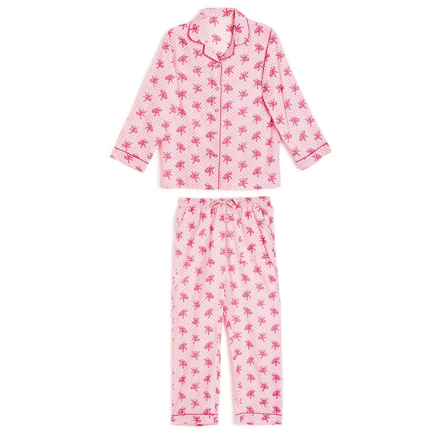 Pink two-piece cotton pajamas with red palm tree print, red piping, button-up top, pants. Sizes: S, M, L. Gift bag included.