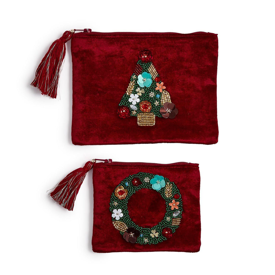 Two red velvet pouches with tassels, featuring beaded Christmas tree and wreath designs.