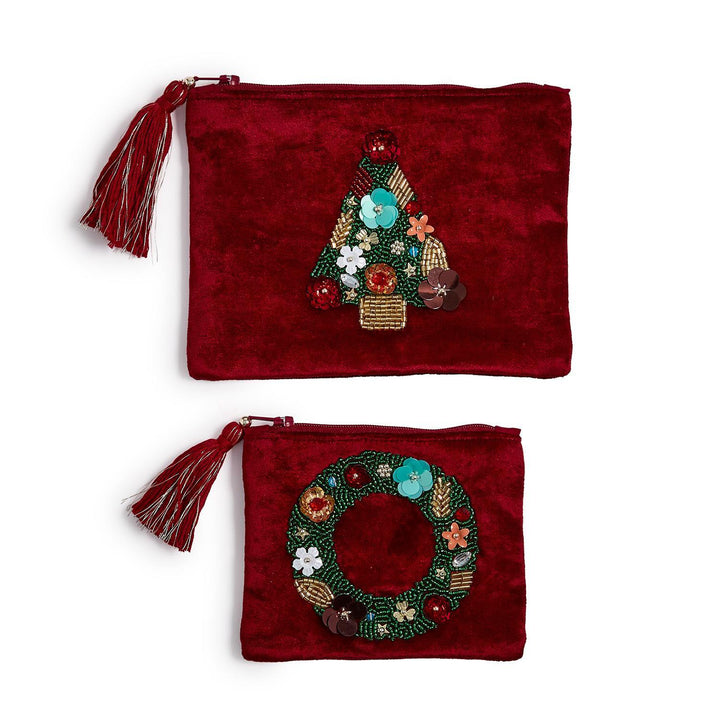 Two red velvet pouches with tassels, featuring beaded Christmas tree and wreath designs.