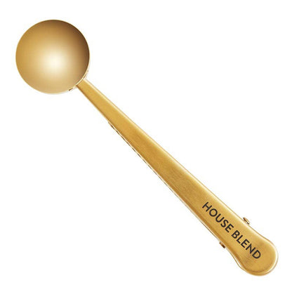Gold stainless steel coffee scoop with round bowl, "HOUSE BLEND" on handle. Available sizes: 1 tbsp and 2 tbsp.