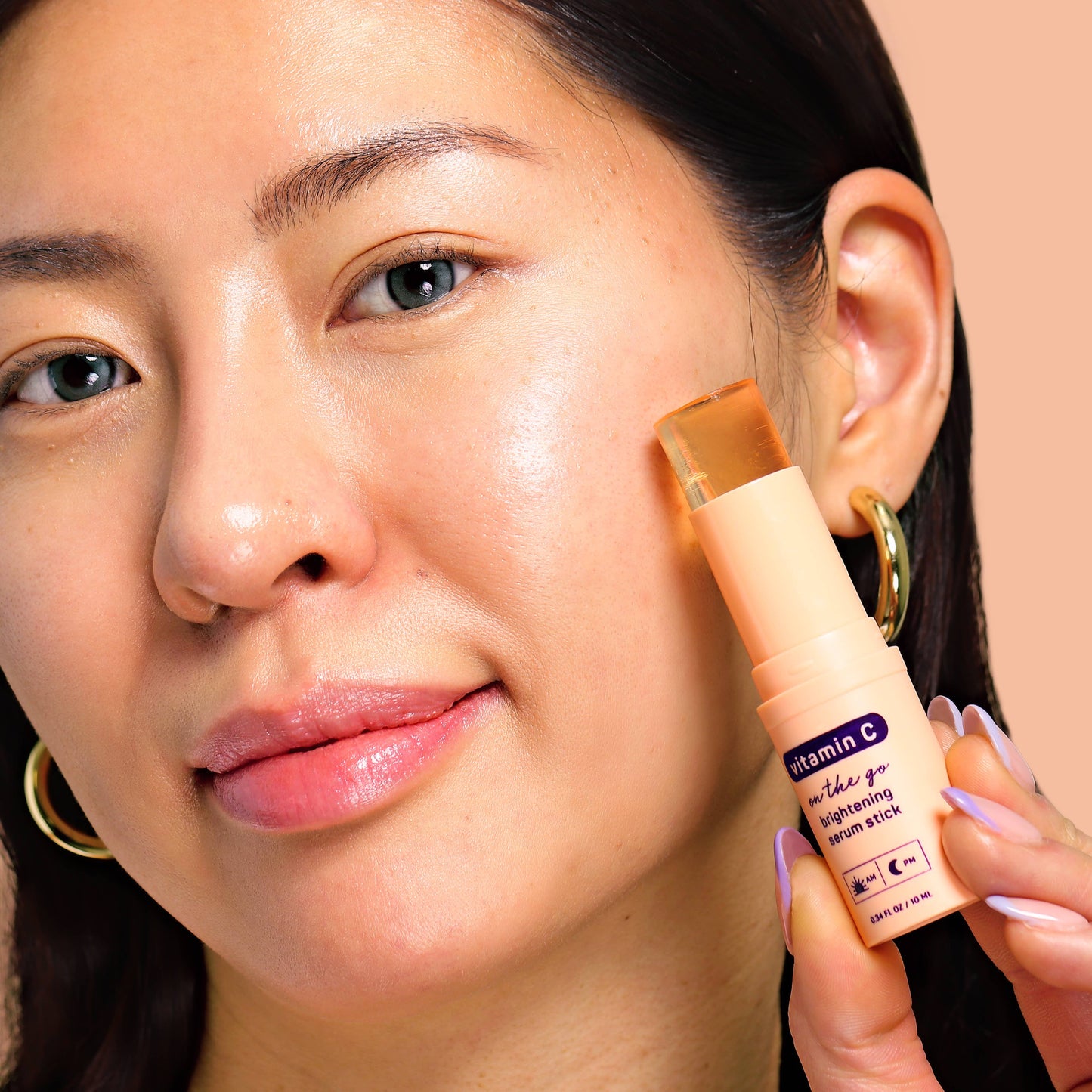 Glow Vitamin C Brightening Face Serum Stick being applied to the cheek; available in 15g and 30g sizes.