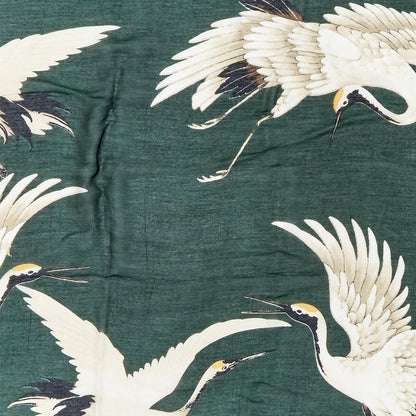 The Heron Print Forest Green Short Kimono features a dark green backdrop with white cranes in flight. Available in sizes S/M and L/XL.