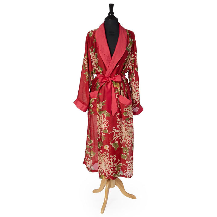 Long red silk robe with chrysanthemum print, wide lapels, and a matching sash belt. Available in S, M, L, XL.