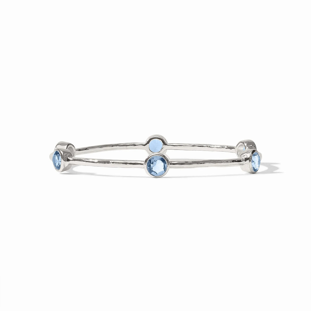 Pure silver plate Milano Bangle with hammered texture and four round blue gemstones. Available in S, M, L sizes.