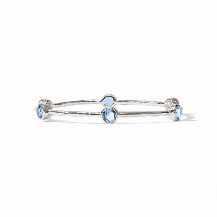 Pure silver plate Milano Bangle with hammered texture and four round blue gemstones. Available in S, M, L sizes.