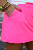 Solid Neon Pink Skort with side pocket detail. Available in sizes XS to XL.