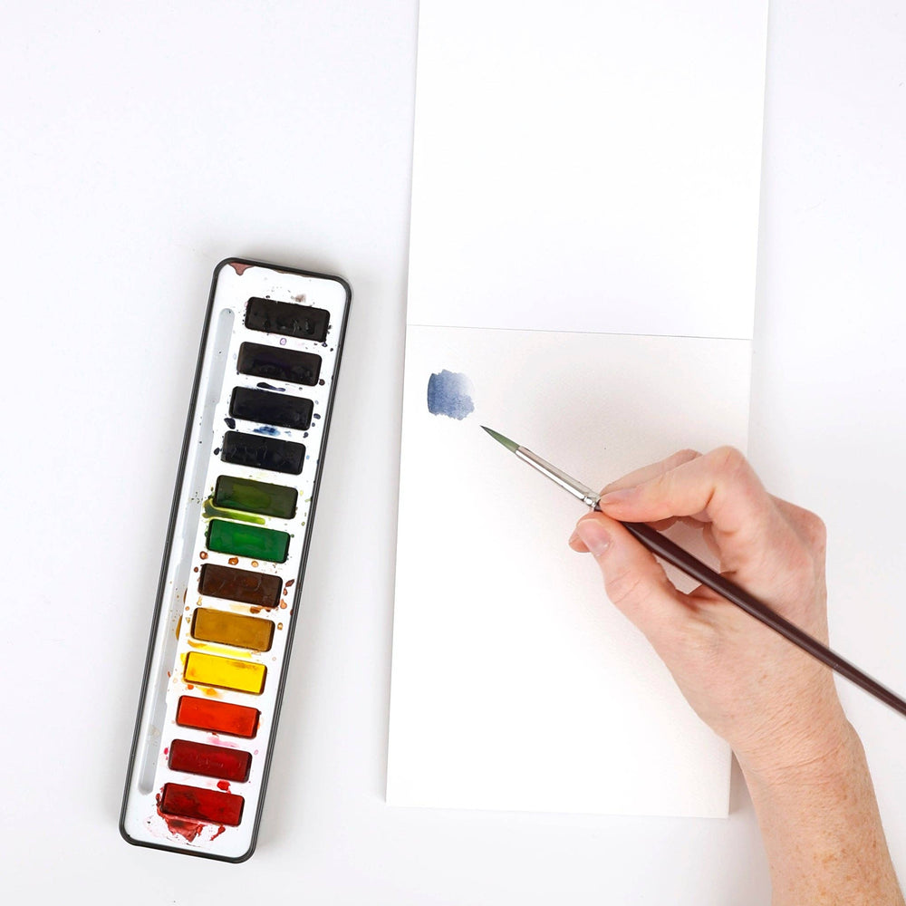 Blue watercolor paint applied with a brush to blank 5x7 watercolor paper. Paper available in 5x7 size.