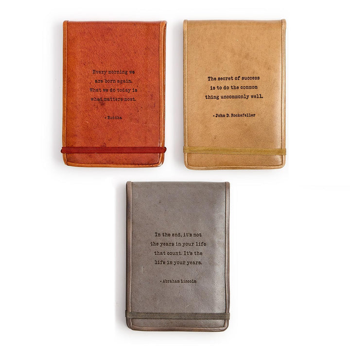 Set of three leather flip notebooks with embossed sayings, available in small, medium, and large sizes.
