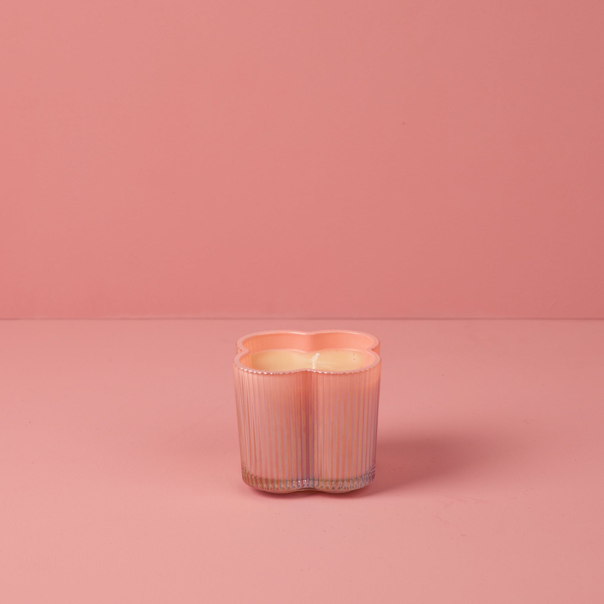 Sweet Grace Collection Flower Candle, 7.2 oz, pink ribbed clover-shaped glass holder, soy-blend wax, unlit.