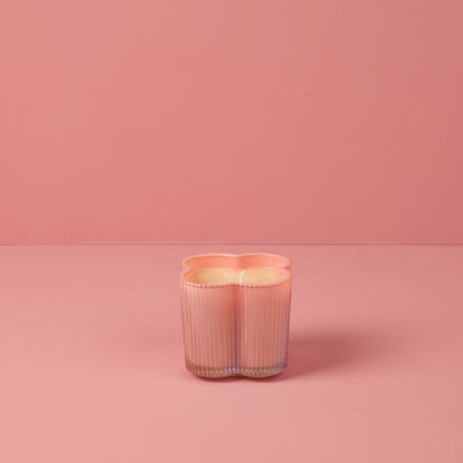 Sweet Grace Collection Flower Candle, 7.2 oz, pink ribbed clover-shaped glass holder, soy-blend wax, unlit.