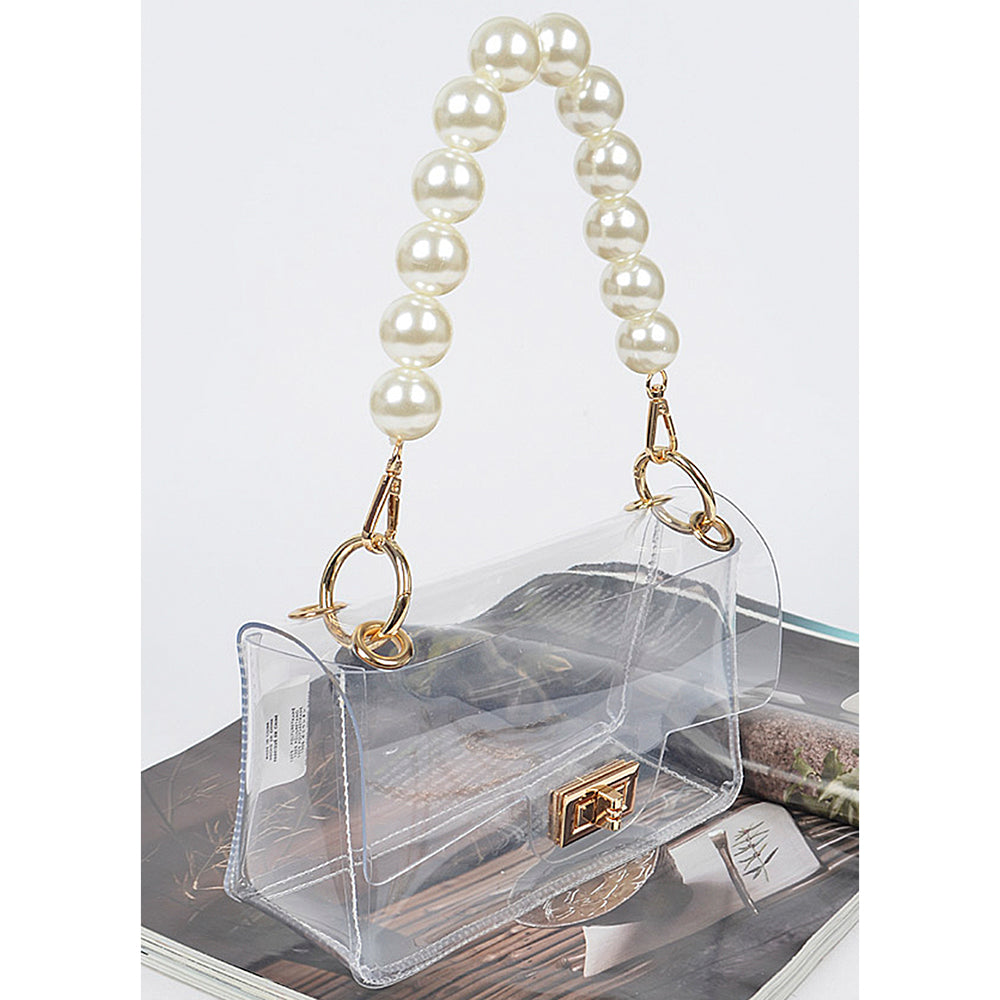 The Clear Bag features a pearl handle and a gold chain crossbody strap. Available sizes: Small, Medium.