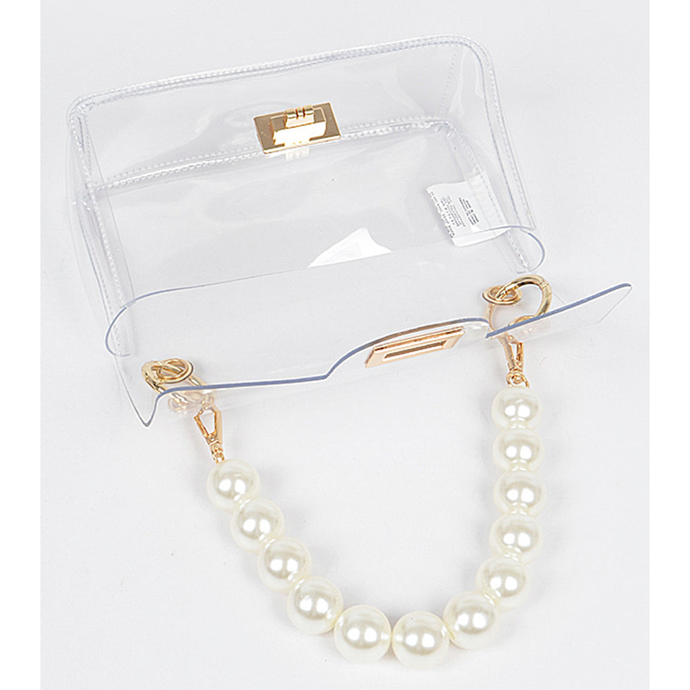 The Clear Bag with Pearl Handle and Gold Chain Crossbody Strap is a rectangular acrylic clutch with a gold-tone clasp. It features a pearl-like handle and comes with a detachable gold chain crossbody strap. Sizes available: One Size.