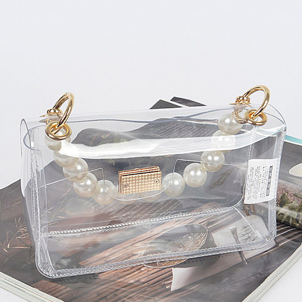 Clear Bag with Pearl Handle and Gold Chain Crossbody Strap: Transparent design with pearl-beaded handles and gold clasp. Includes optional gold chain strap for versatility. Available size: One size.