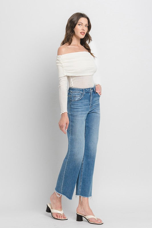 White off-the-shoulder long sleeve top. Sizes: XS, S, M, L.

High Rise Dad Jeans with raw hems. Sizes: 24, 25, 26, 27, 28.