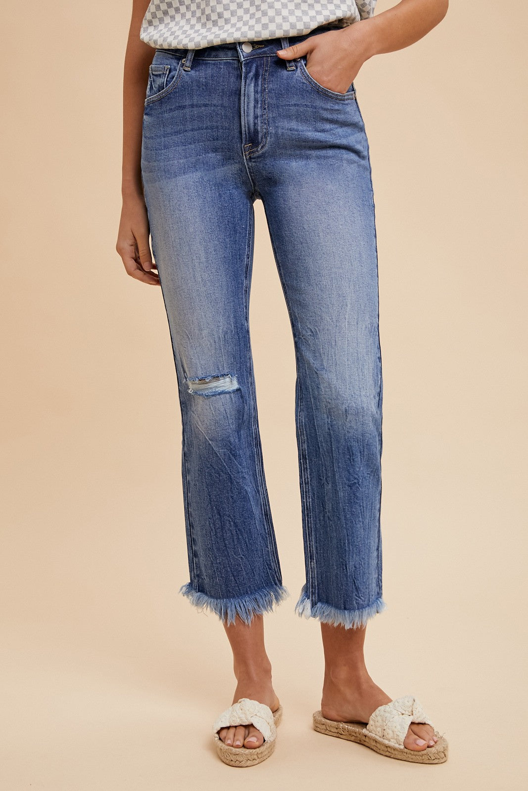 High-waisted, slightly distressed Comfort Stretch Straight Leg Frayed Hem Jeans. Sizes available: 24-32.