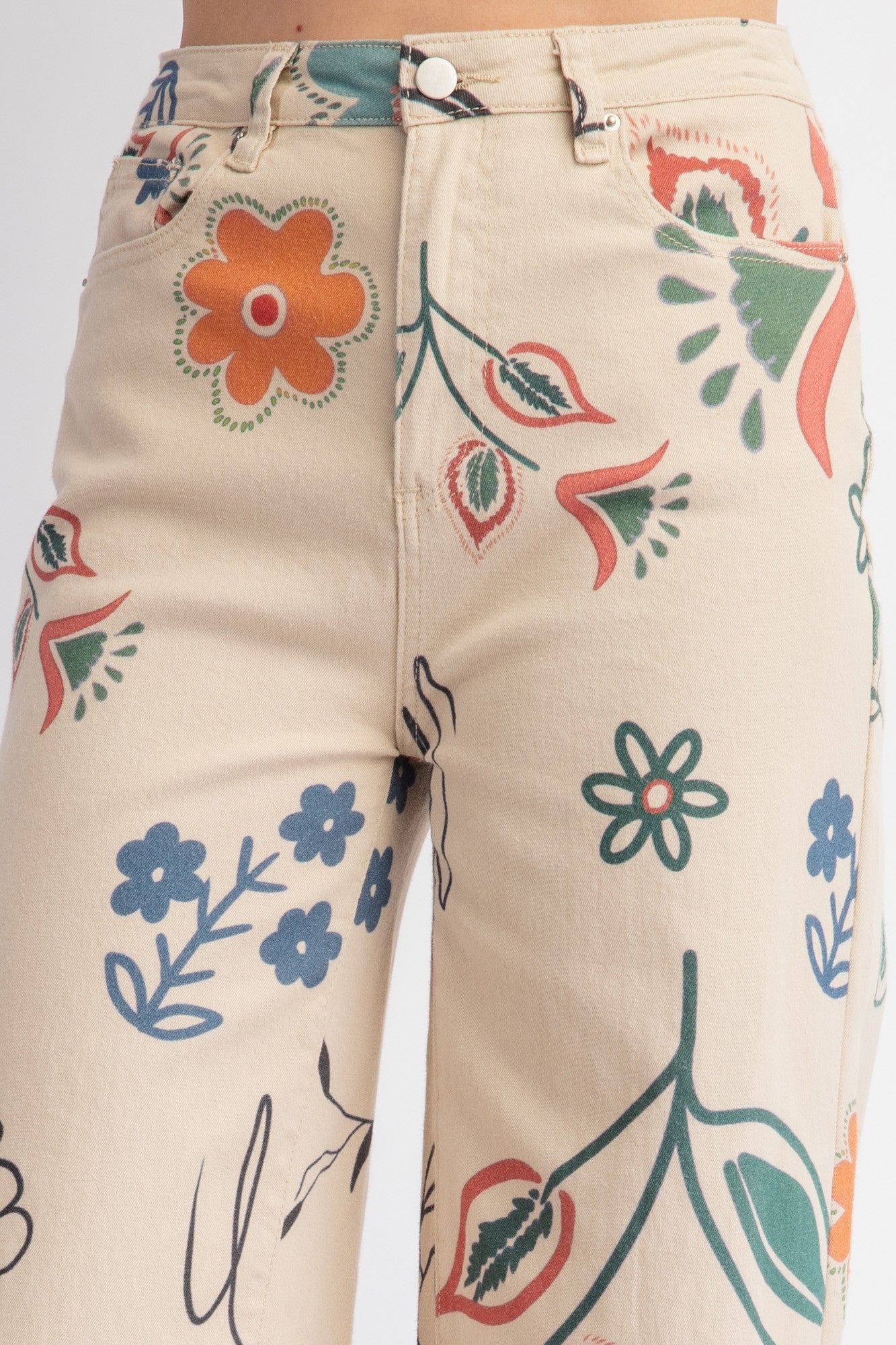 Printed Washed Twill Wide Pants feature a vibrant floral print in red, green, blue, and orange with blossoms, leaves, and abstract shapes. Relaxed and loose fit. Available sizes: S, M, L.