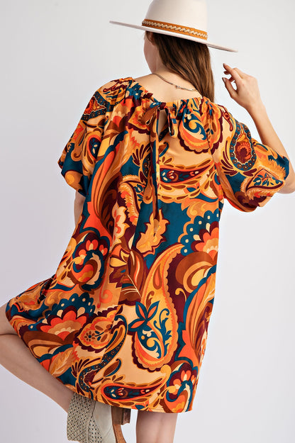Sophia Printed Tie Back Dress in a bold retro paisley print (orange, blue, red). Keyhole tie at the back. Sizes: XS, S, M, L.