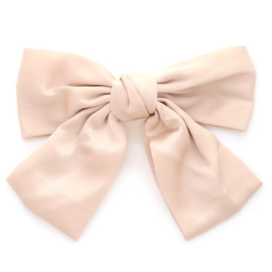 **Handmade Satin Hair Bow Clip:** Large, elegant accessory crafted from beige satin with wide, flowing ribbons in a symmetrical shape. Available in one size.