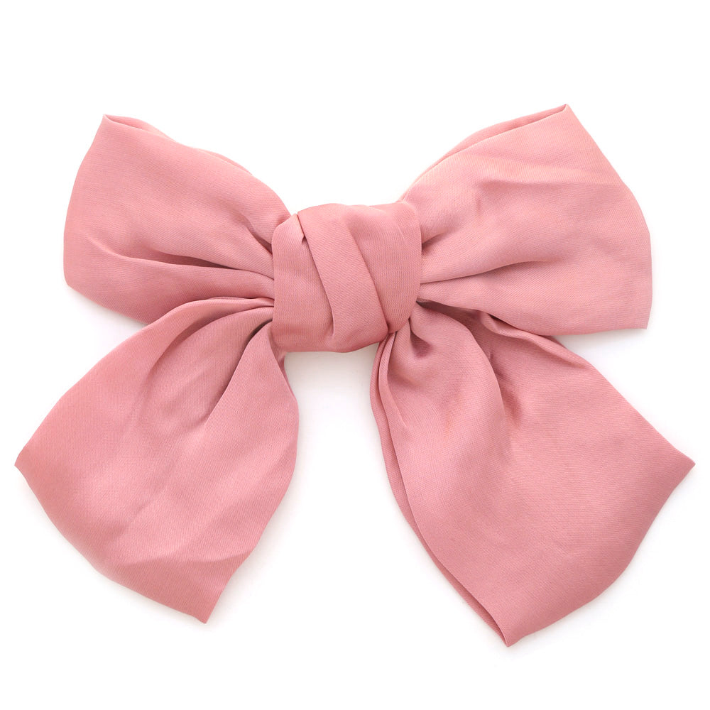 Handmade Satin Hair Bow Clip in pink with a wrinkled surface, neat center knot, and draped tails. Sizes available: Small, Medium, Large.