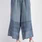 Mineral Washed Chambray Wide Leg Capri Pants. Features: drawstring waist, horizontal stitched details near the bottom, cropped just above the ankles. Sizes available: S, M, L, XL.