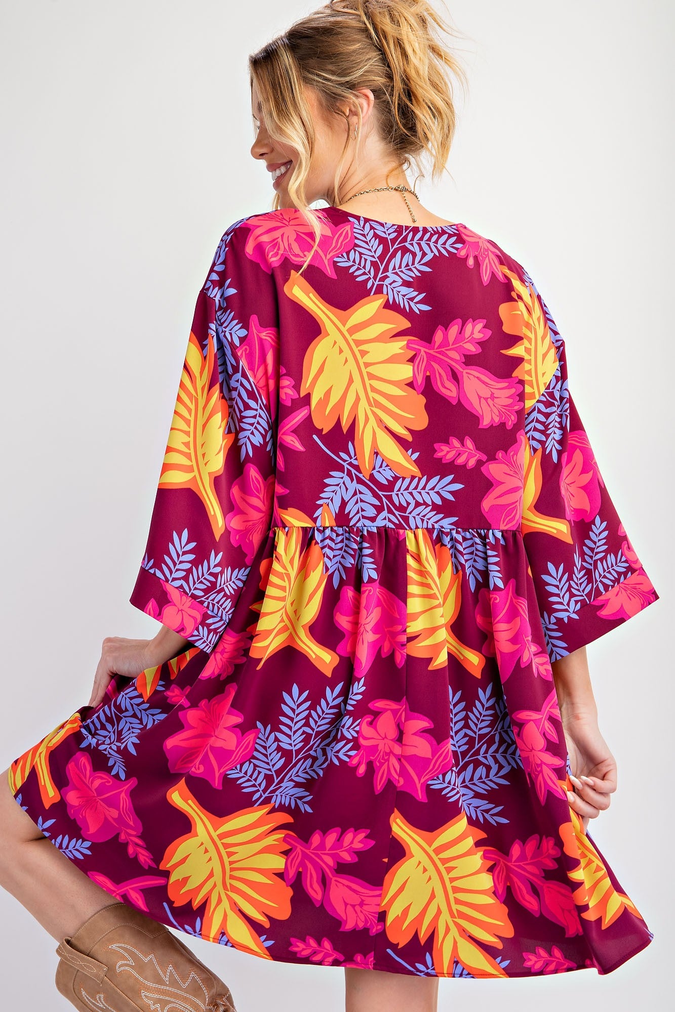 The Printed Sophia Twill Woven Dress features tropical leaf and floral prints in pink, orange, and purple. Available in sizes XS to XL.