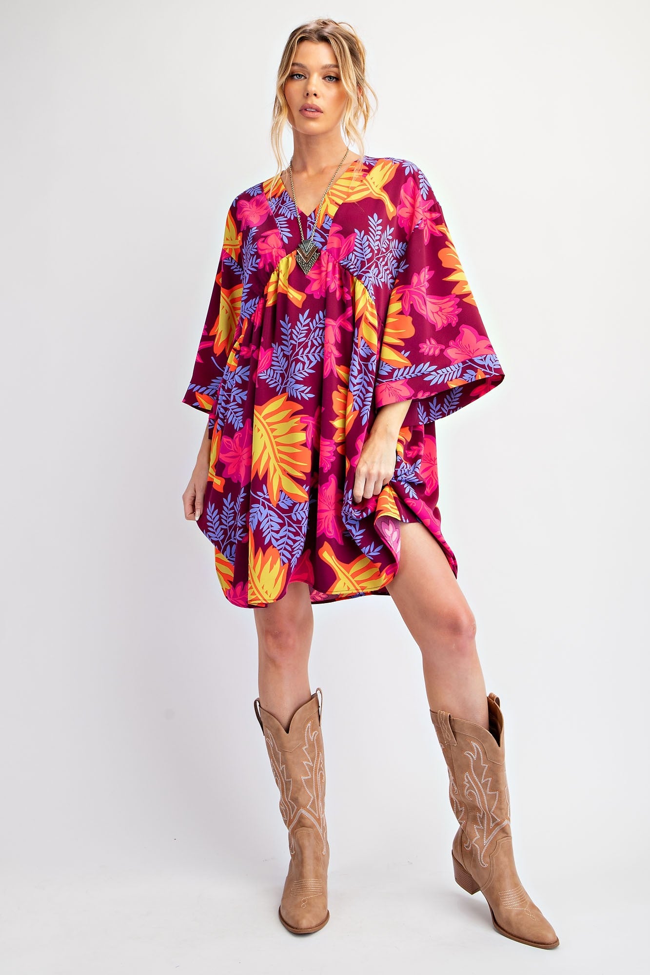 Colorful floral print kaftan with vibrant pink, orange, and blue designs. Available in sizes S, M, L, XL.