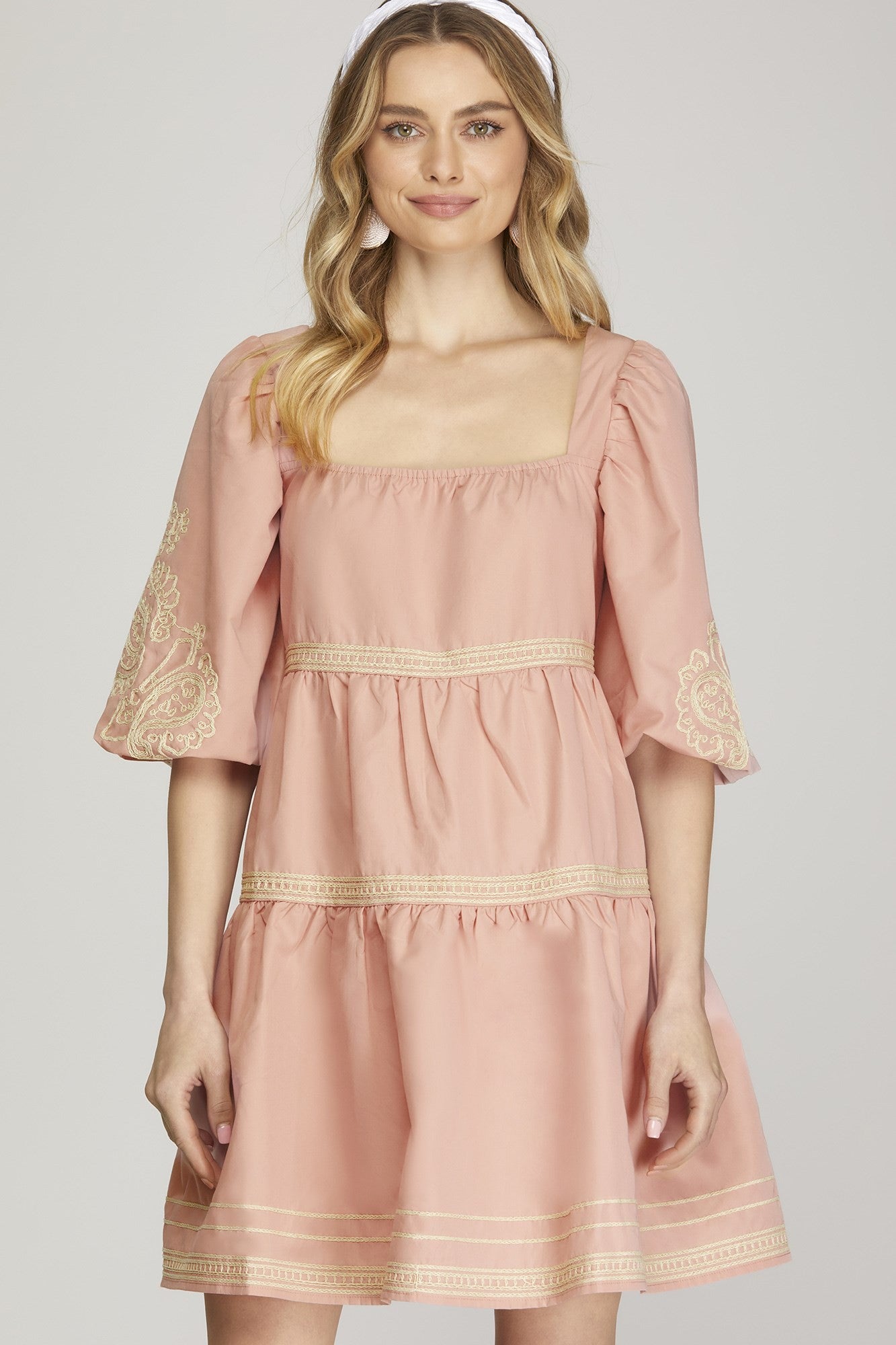 Blossom Cascade Dress: Light pink with intricate embroidery on puff sleeves, square neckline, and tiered skirt. Available sizes: XS, S, M, L, XL.