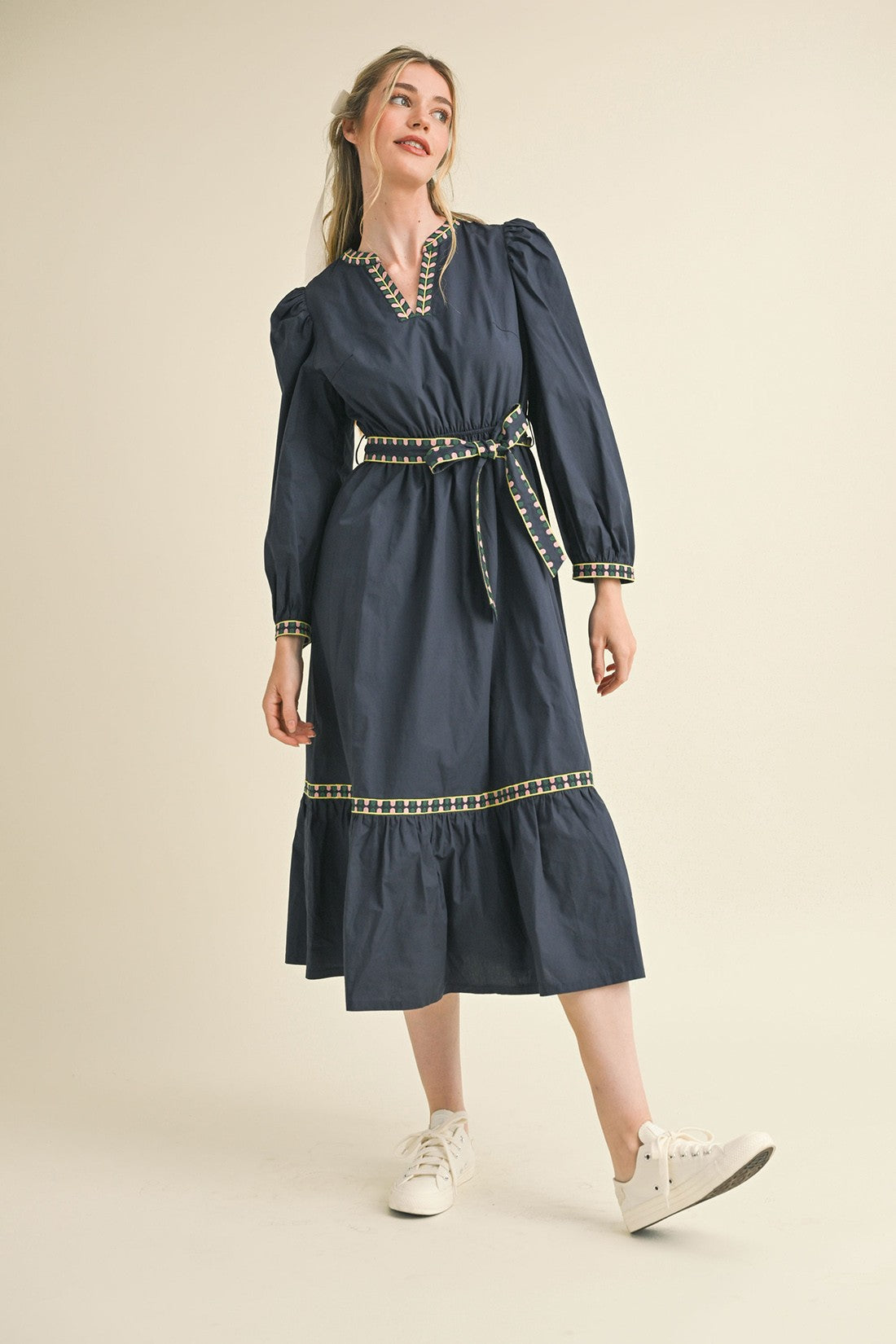 Kathy Embroidered Belt Midi Dress in navy with gold and white trim, tiered skirt, long sleeves. Sizes: XS-XL.