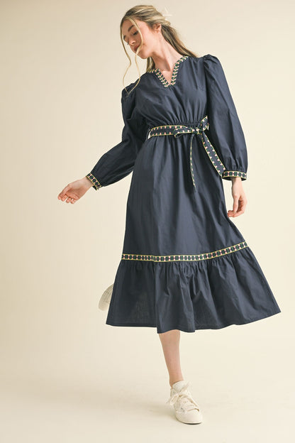 Kathy Embroidered Belt Midi Dress in navy blue with colorful trim and matching belt. Available in sizes XS–XL.