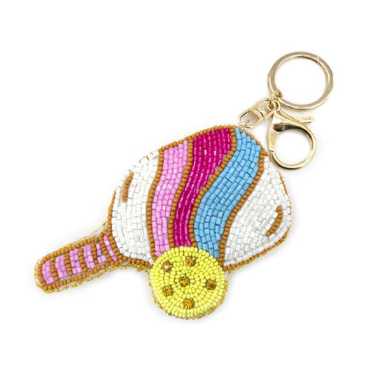 Pickleball Keychain: Beaded accessory shaped like a racquet and ball. Features vibrant beads in pink, purple, blue, yellow, and white with a gold keyring and clasp. Sizes available: One size.