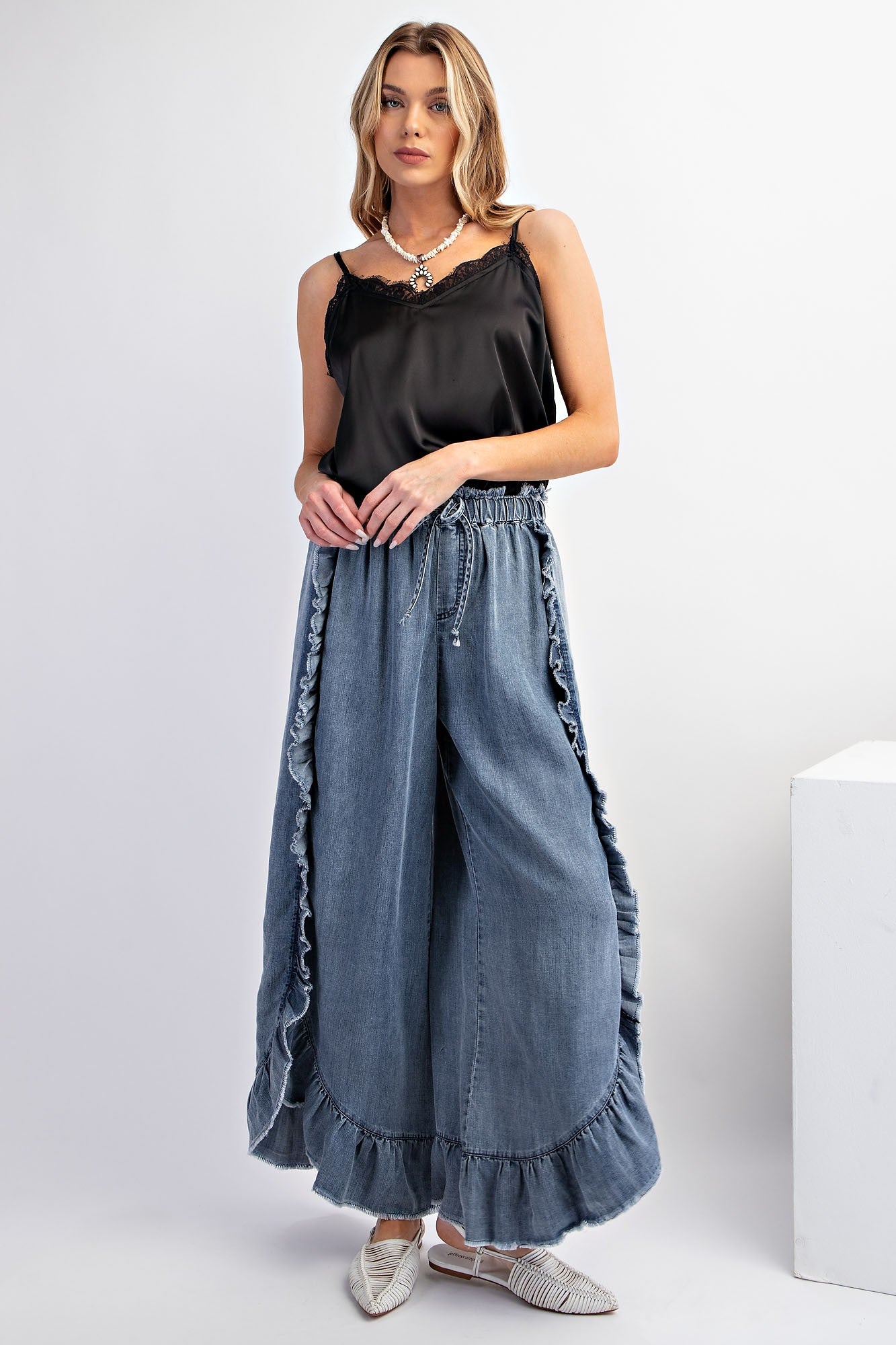 Washed Ruffle Chambray Loose Fit Pants: Black, wide-legged, lace-trimmed. Sizes: XS, S, M, L.