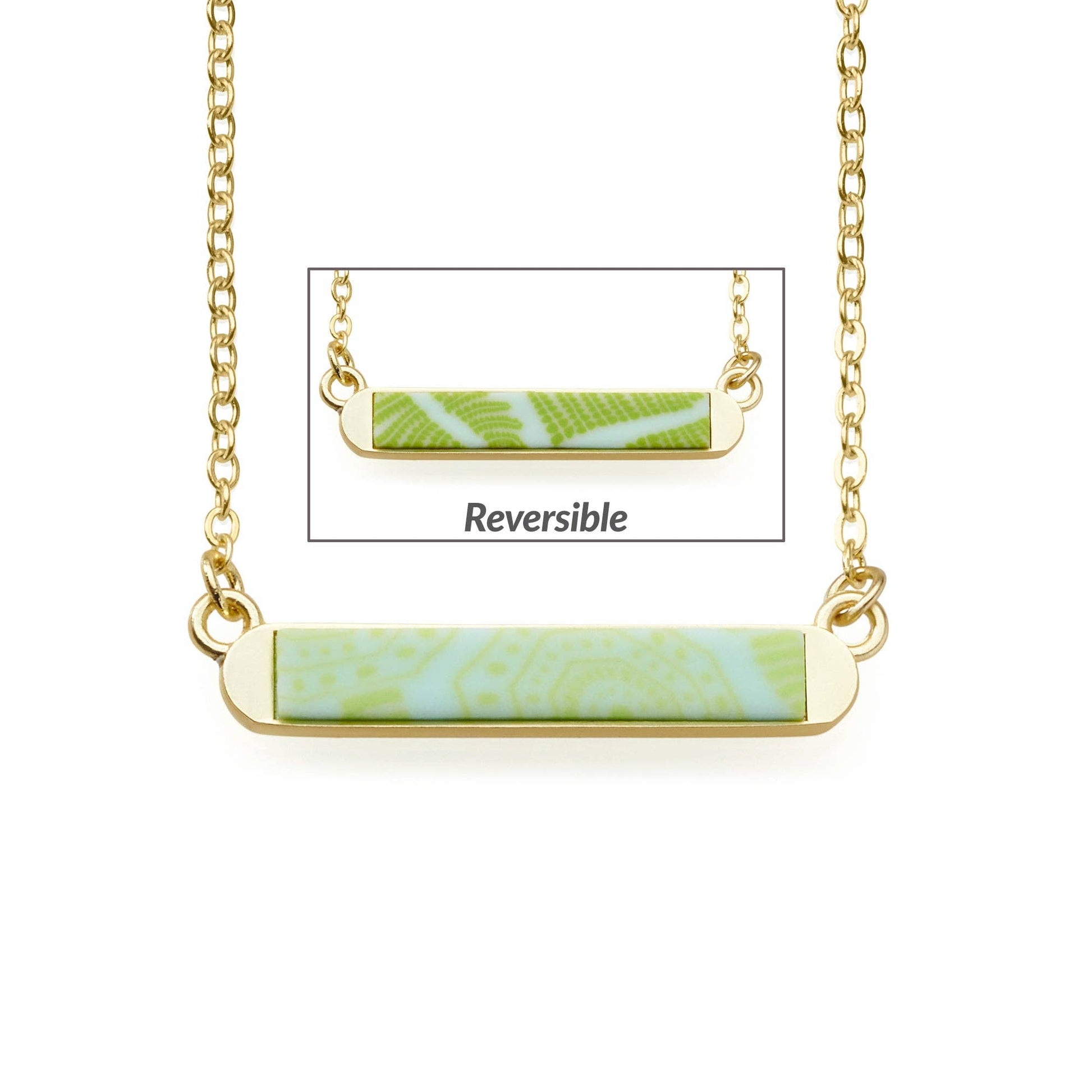 Seaside Green Reversible Mini Bar Necklace. Delicate chain with a rectangular pendant featuring green patterns on a white background. Handcrafted and reversible, showcasing a different green pattern on the reverse. Available in 16-inch, 18-inch, and 20-inch lengths.