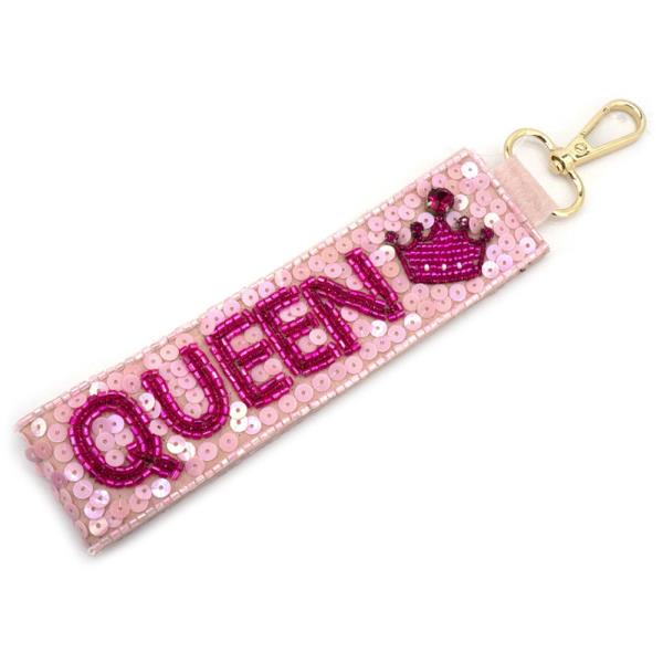 Queen Wristlet Strap: Pink strap with sequin "QUEEN" keychain and crown design. Gold clasp included. Sizes available: One size fits all.