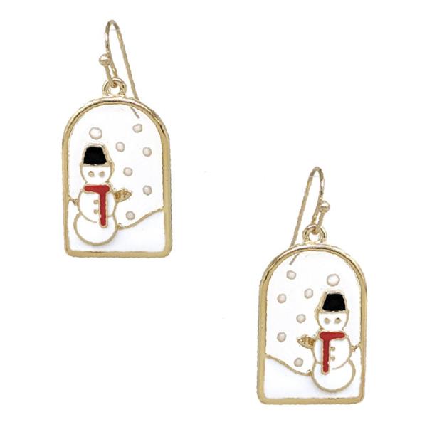 The Joy of Christmas Festive Earrings feature gold-framed snowmen with red scarves and black hats, set in an arched snowy backdrop. Perfect for holiday cheer. Available size: One size.