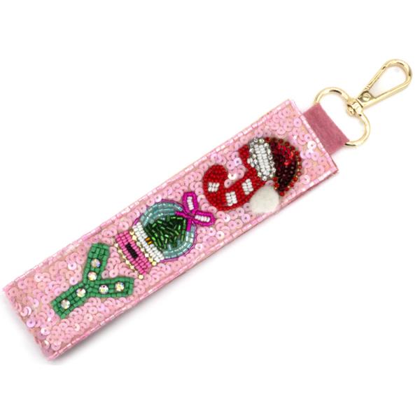 Christmas Spirit Keychain: Pink rectangular keychain with sequins and beaded candy and Santa hat designs. Gold clasp for attachment. Available sizes: One size.