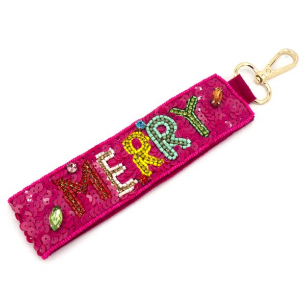 The Christmas Spirit Keychains feature a pink fabric design with sequins spelling "MERRY" and a gold lobster clasp. Perfect for spreading holiday joy. Sizes available: One size.