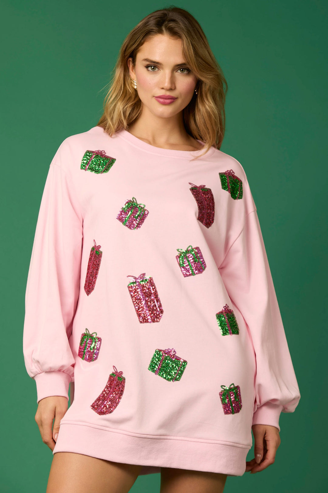 Light pink festive long sleeve crew neck dress with sequined gift box appliqués. Available in various sizes.